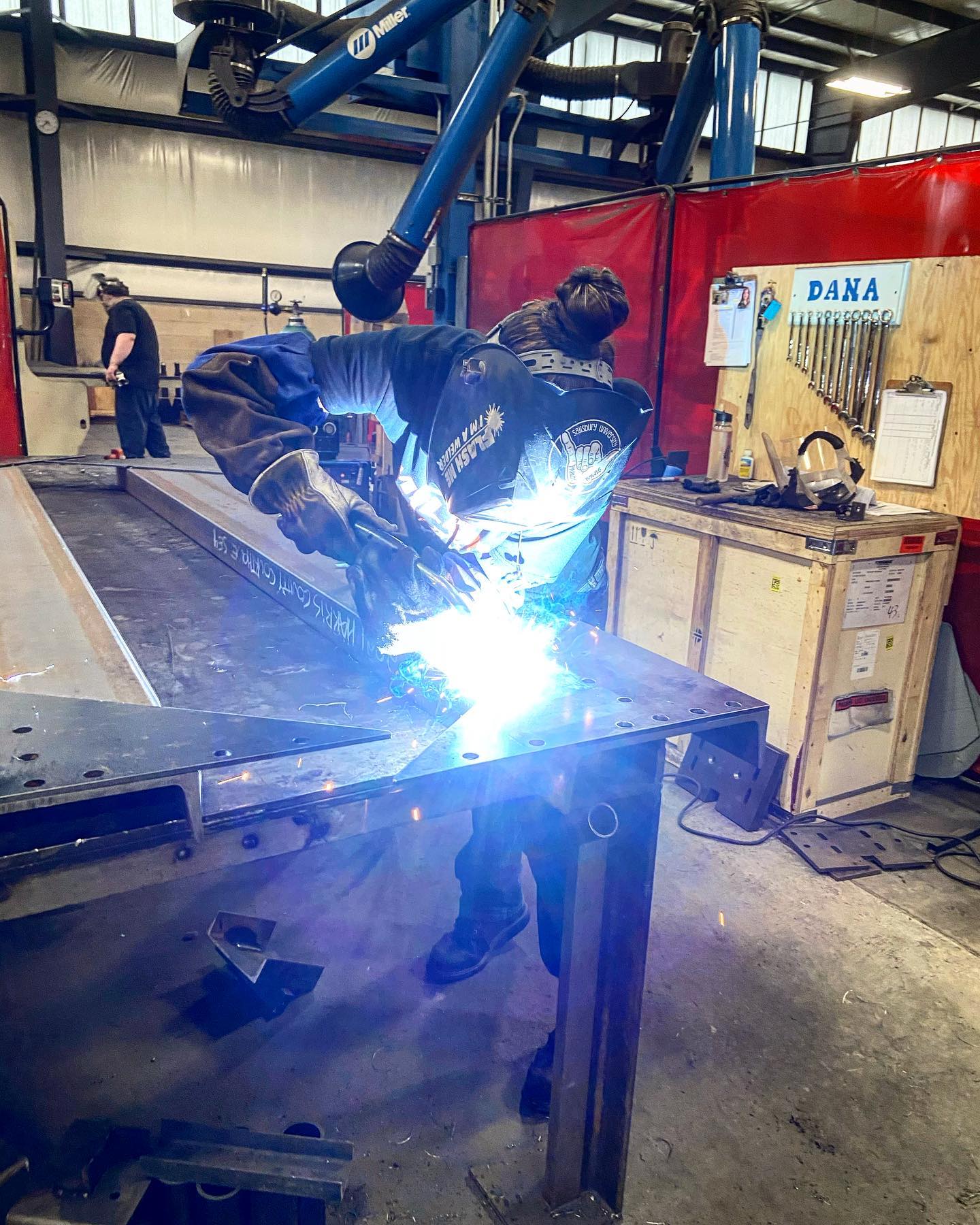 welder working on a piece of metal in a factory